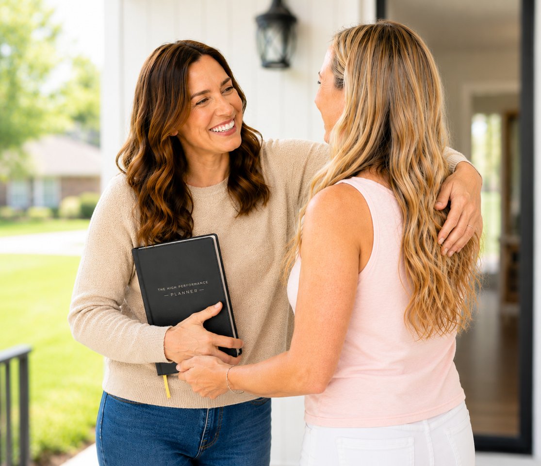 Dr. Tara Perry embracing a client on the front porch after a session, planner in hand